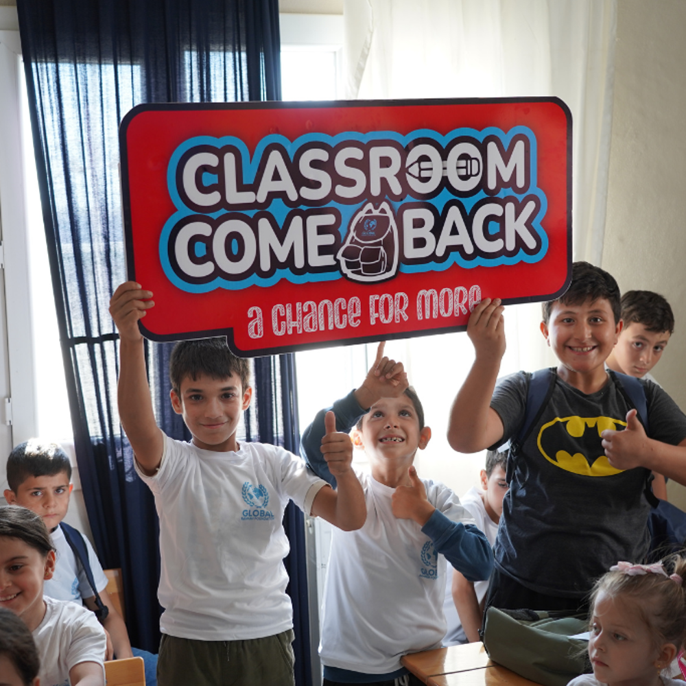 children holding classroom comeback sign GRF