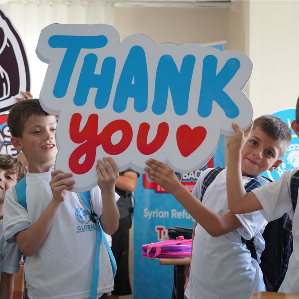 children holding thank you sign GRF