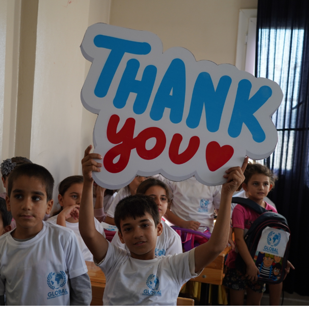 children holding thank you sign to GRF donors