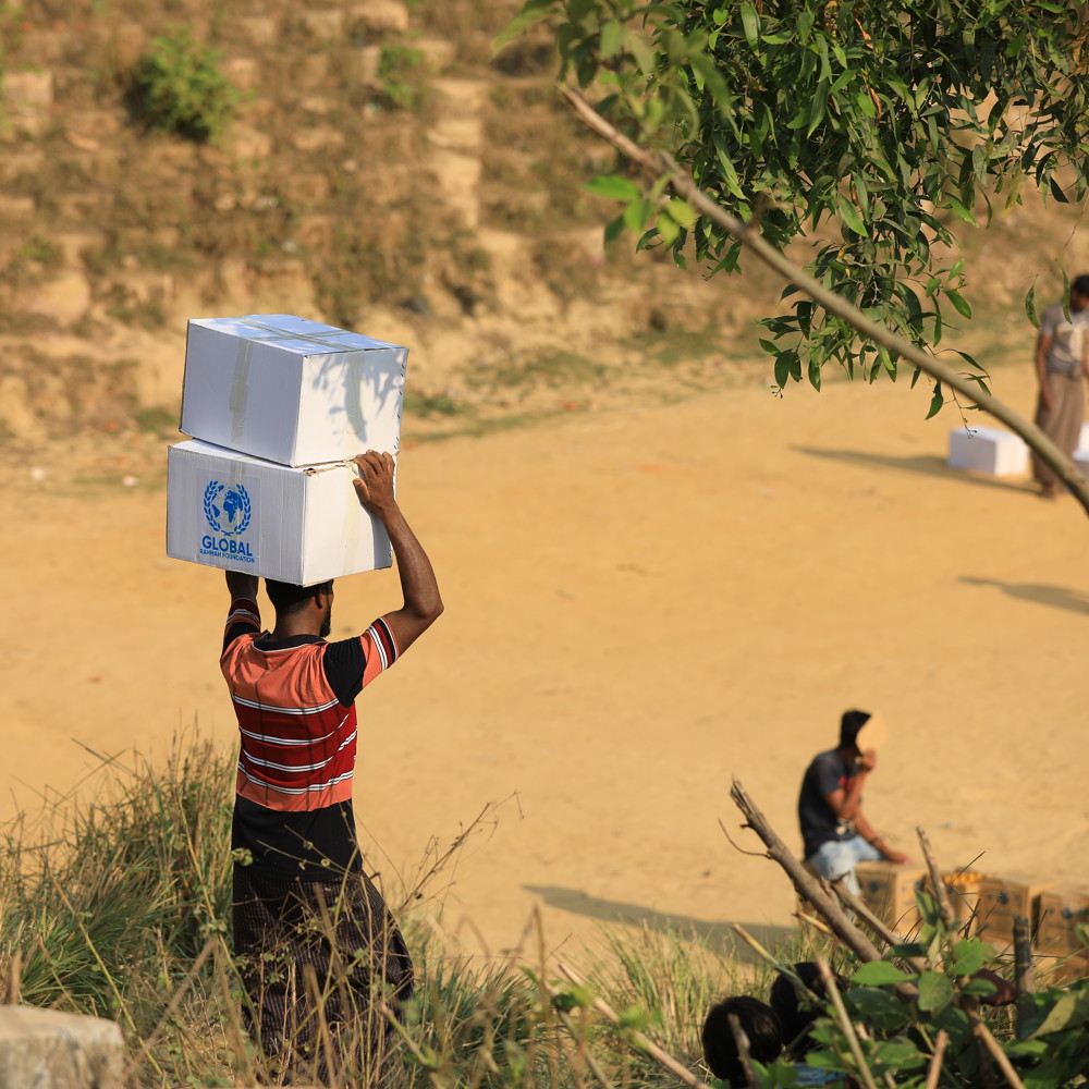 man holding boxes of GRF aid