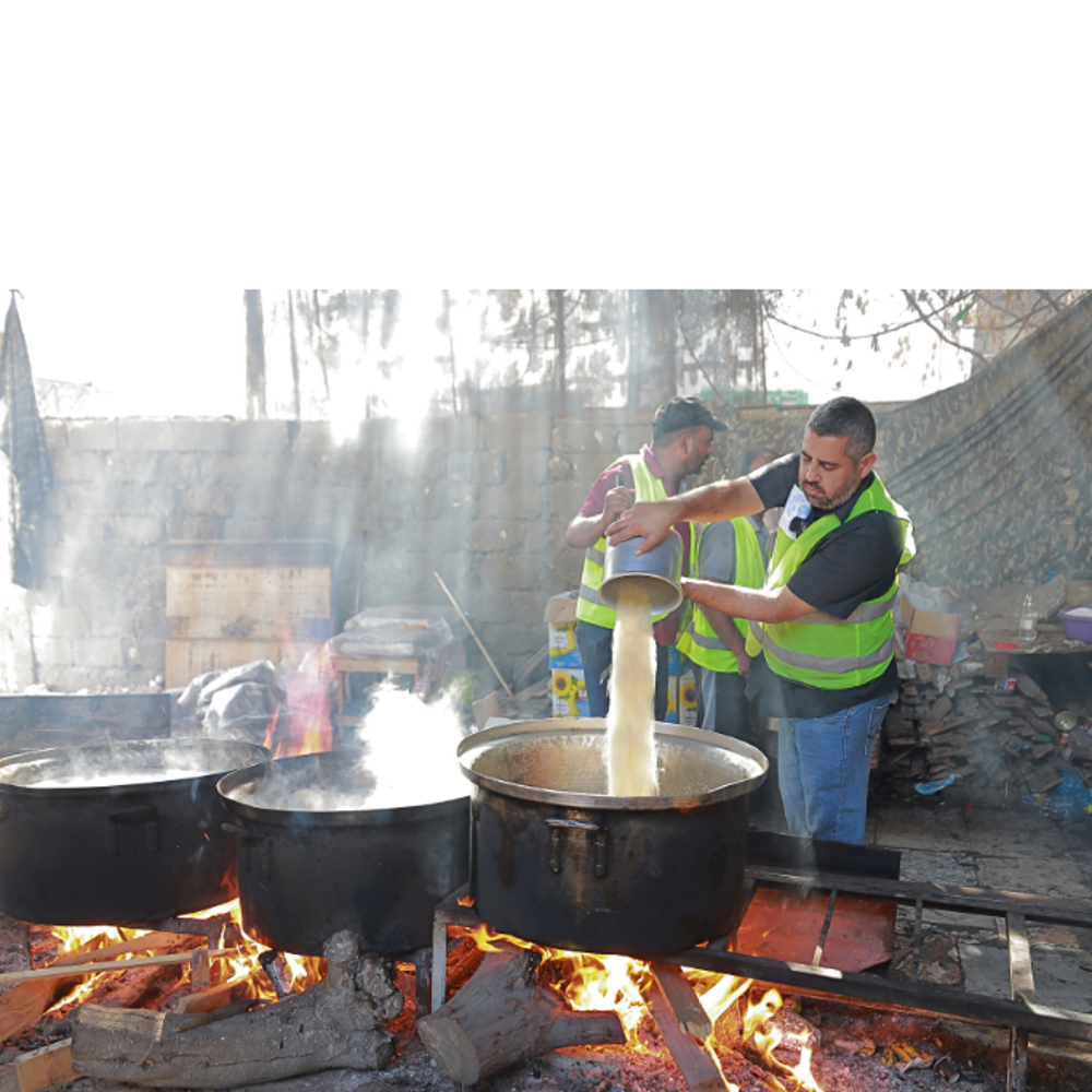 2 GRF team members cooking hot meals