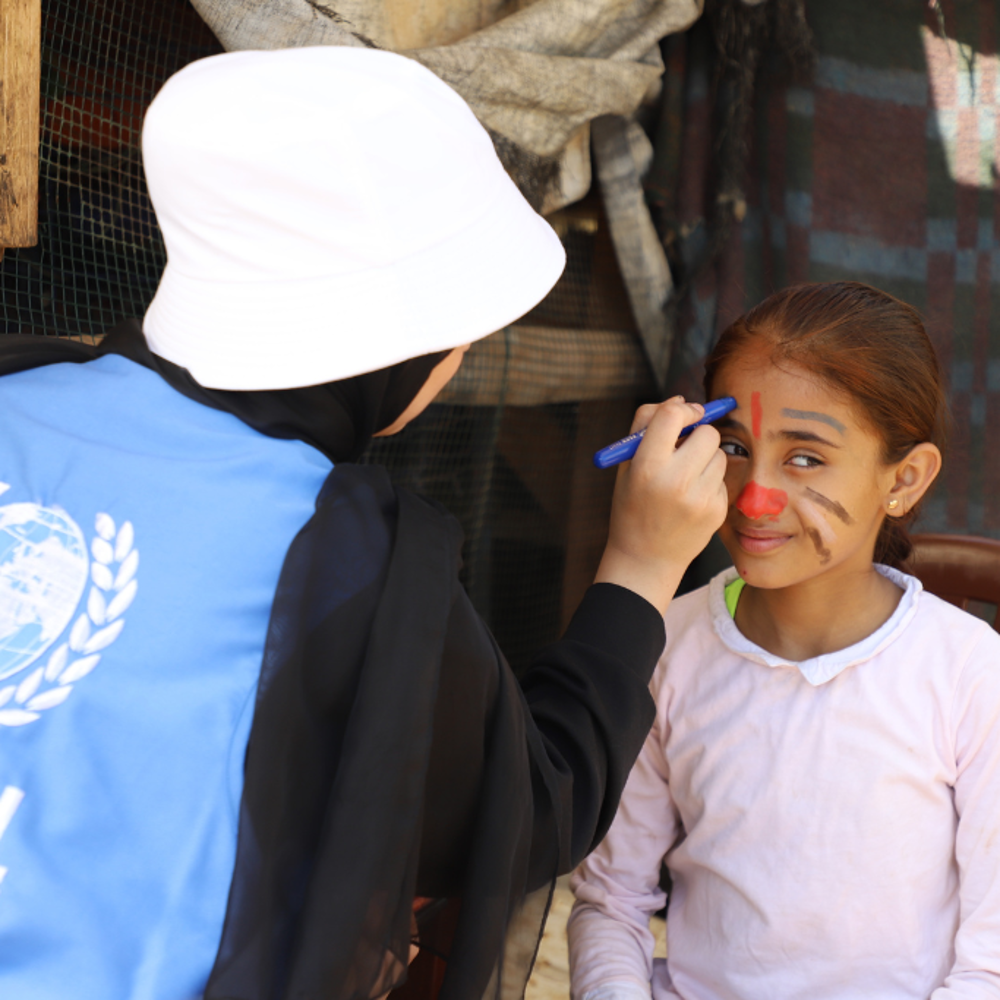 GRF team member painting a child's face